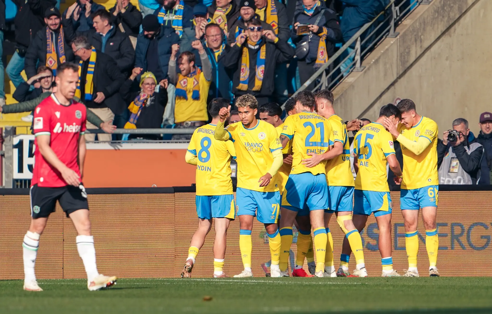 Eintracht Braunschweig players celebrate their derby victory over Hannover 96.