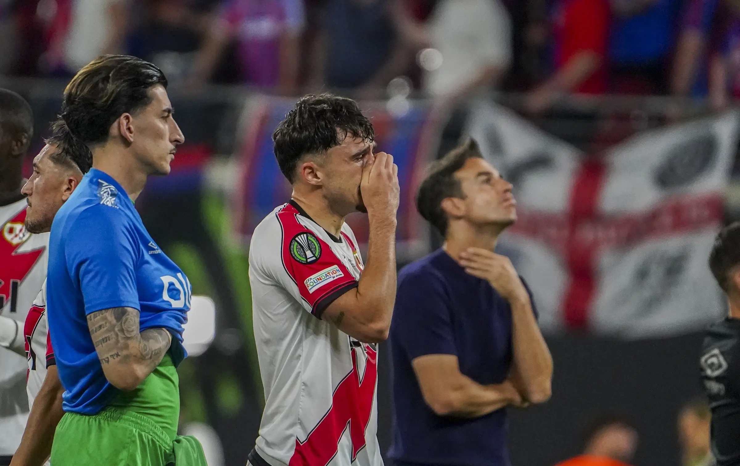 Rayo Vallecano players and supporters absorb defeat after the final whistle.