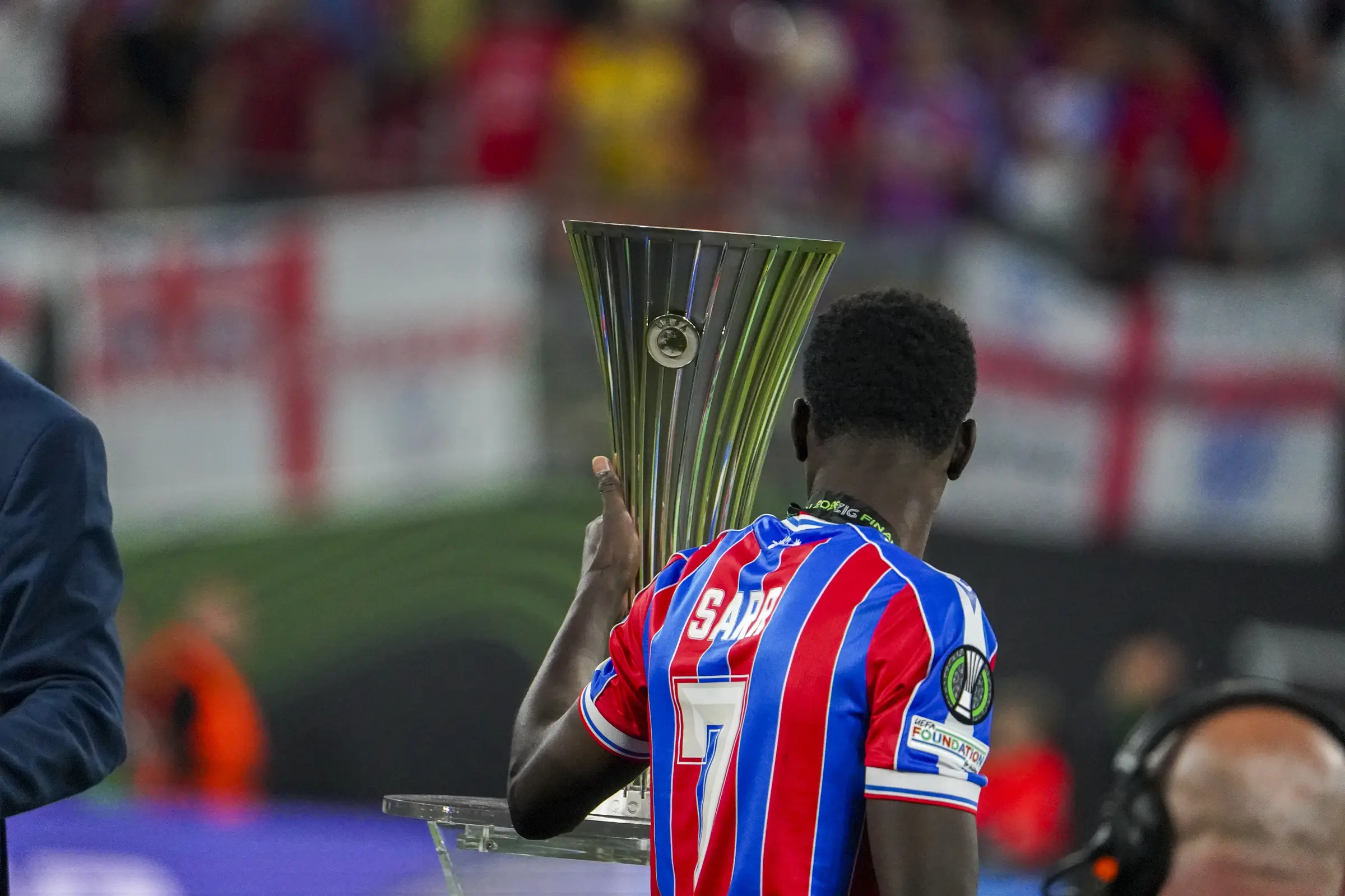 A Crystal Palace player carries the Conference League trophy after the final.