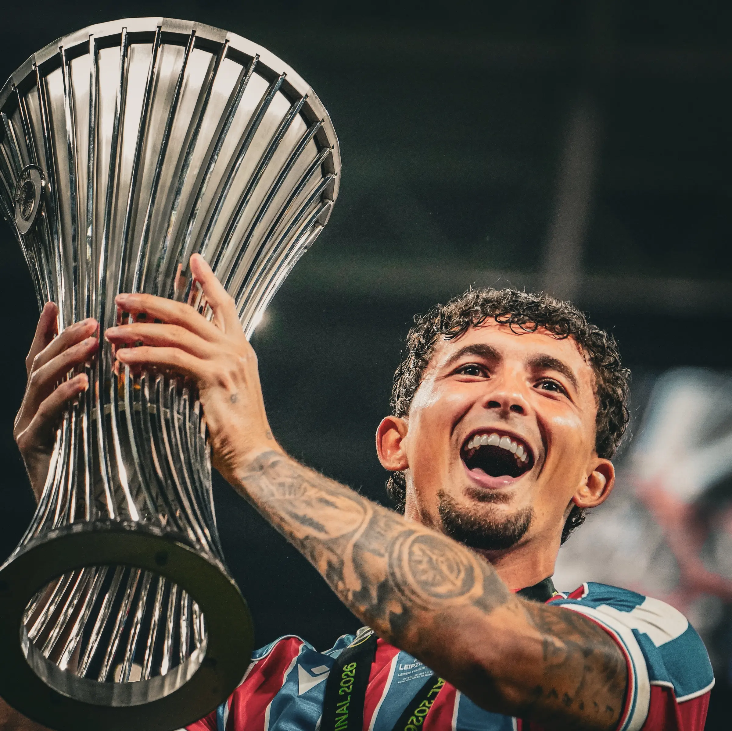 A Crystal Palace player poses with the Conference League trophy.