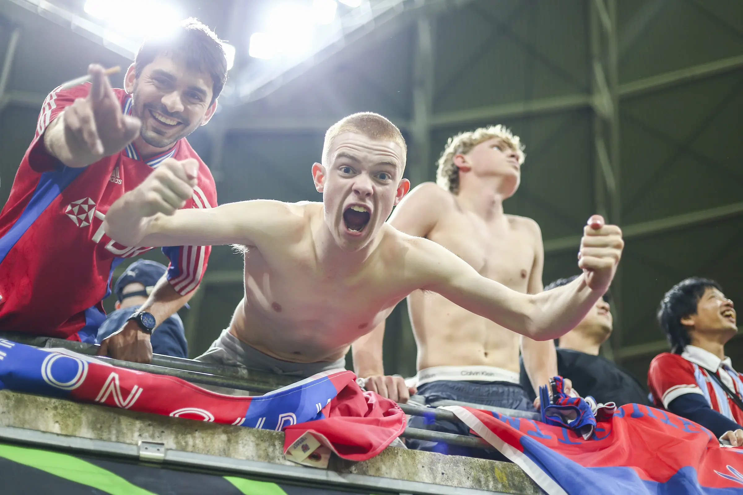 Crystal Palace players celebrate their European title with supporters at the barrier.