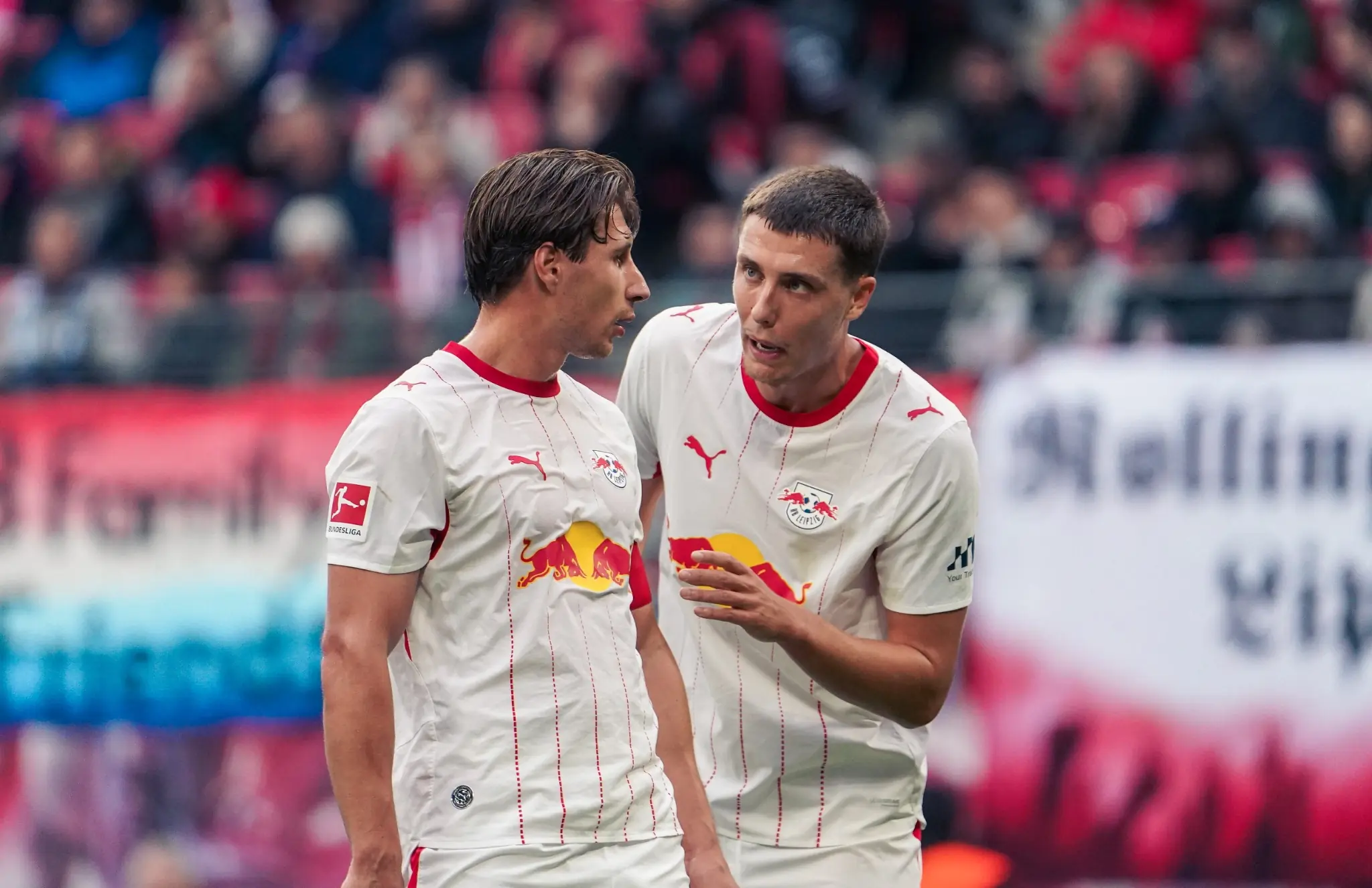 Two RB Leipzig players speak during the Bundesliga match against SV Elversberg.