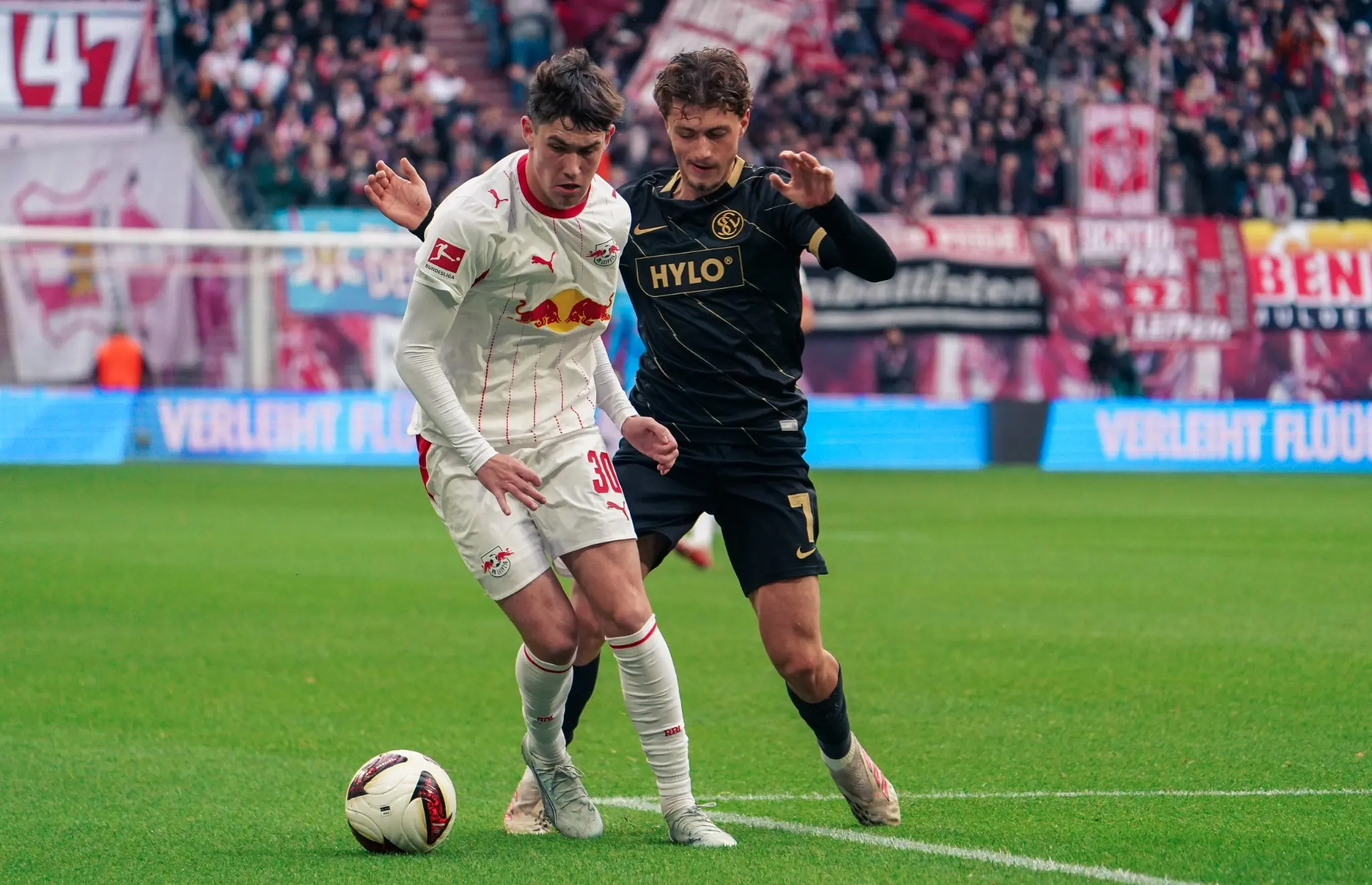 A close midfield duel during RB Leipzig against SV Elversberg at the Red Bull Arena.