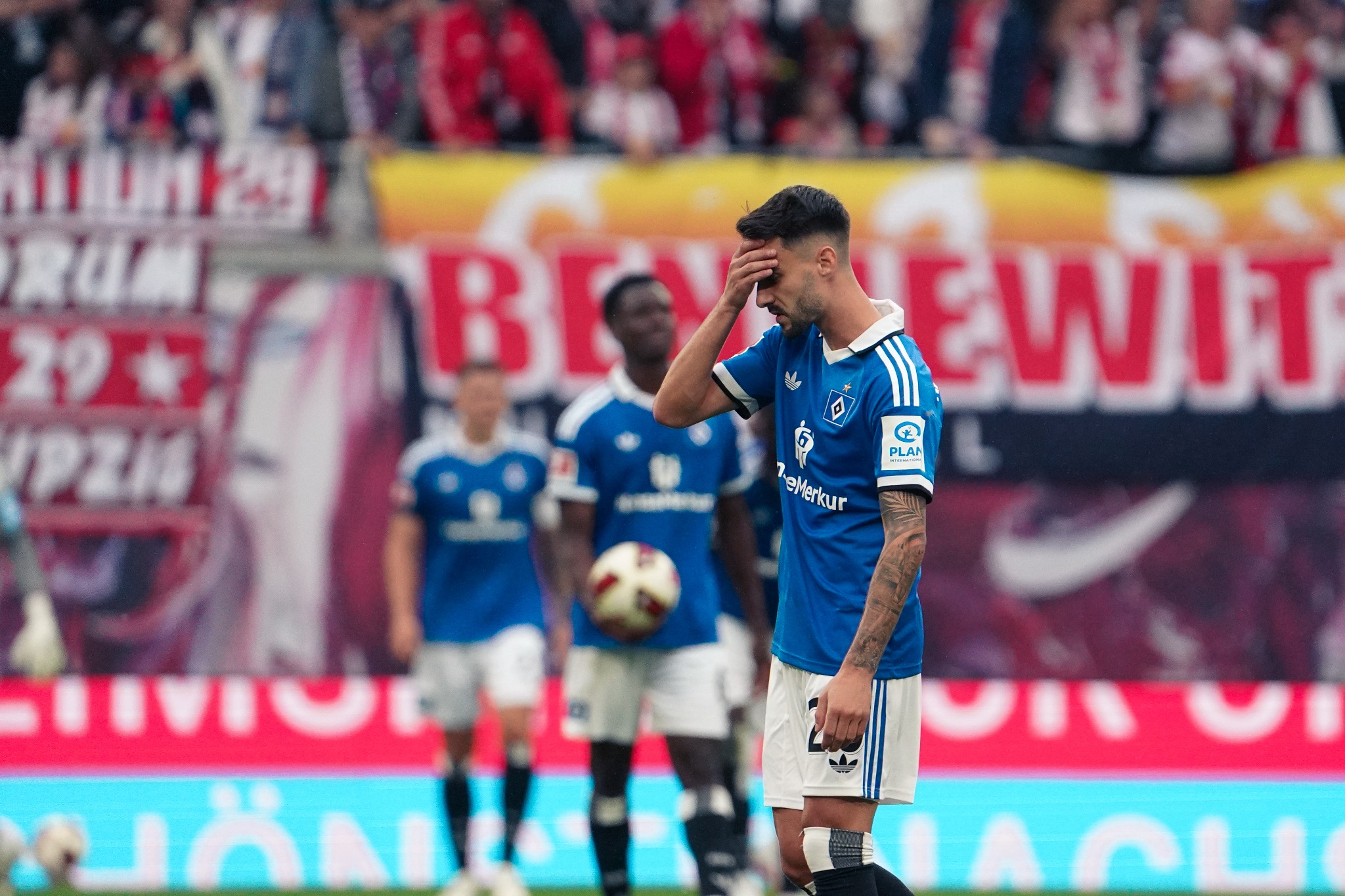 A Hamburger SV player shows disappointment against RB Leipzig.