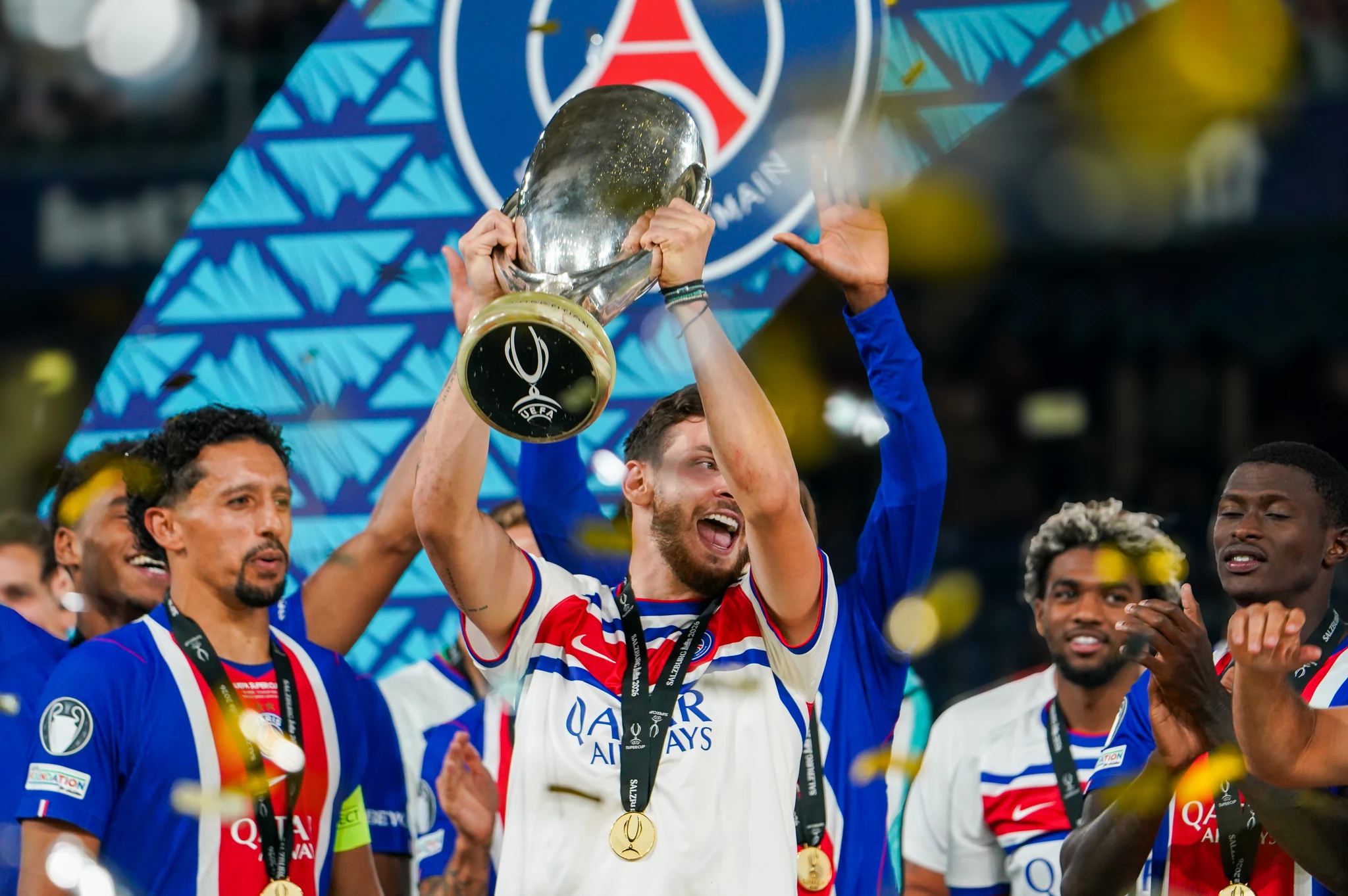 Paris Saint-Germain players celebrate with the UEFA Super Cup trophy.