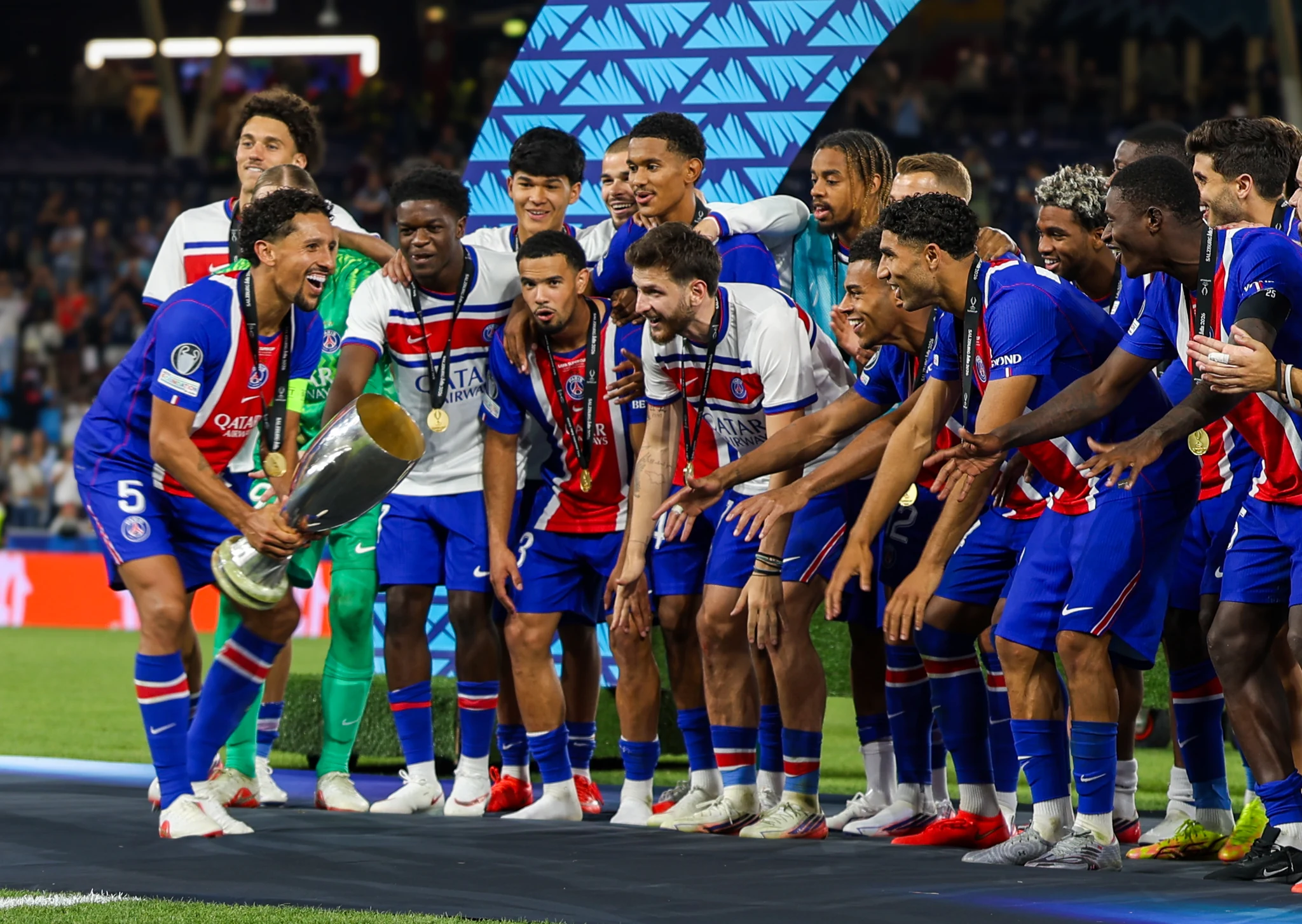 Paris Saint-Germain players celebrate with the UEFA Super Cup trophy.