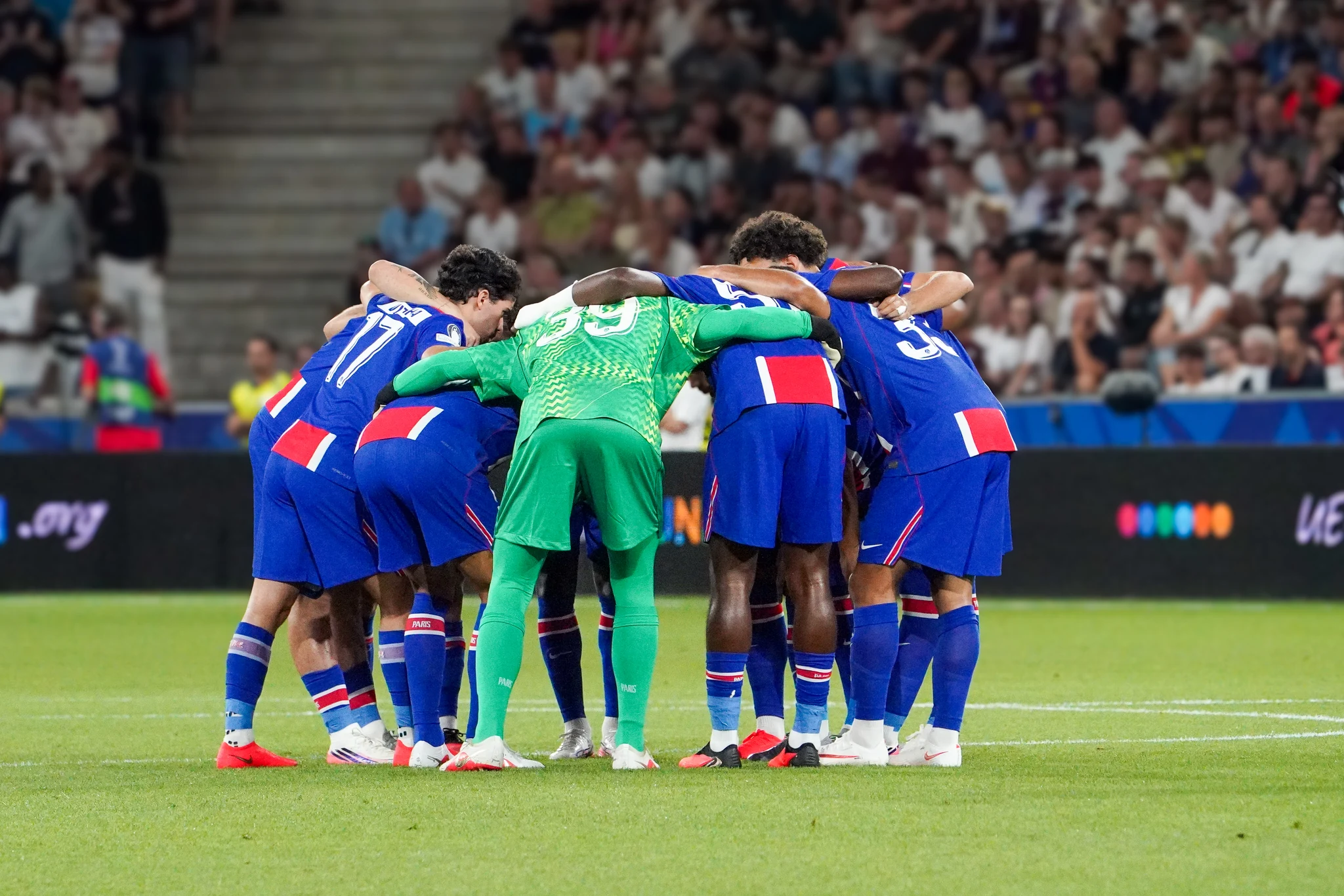 Paris Saint-Germain gather in a team huddle before kick-off.