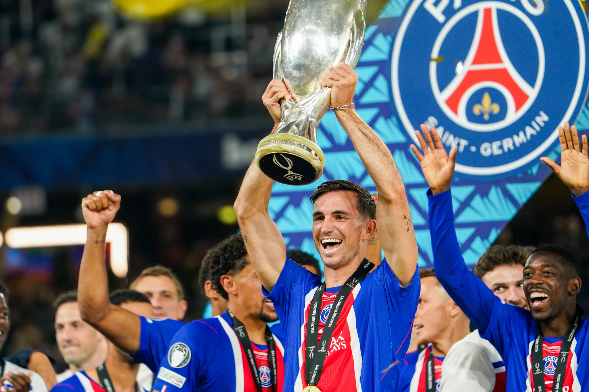 Paris Saint-Germain players celebrate with the UEFA Super Cup trophy.