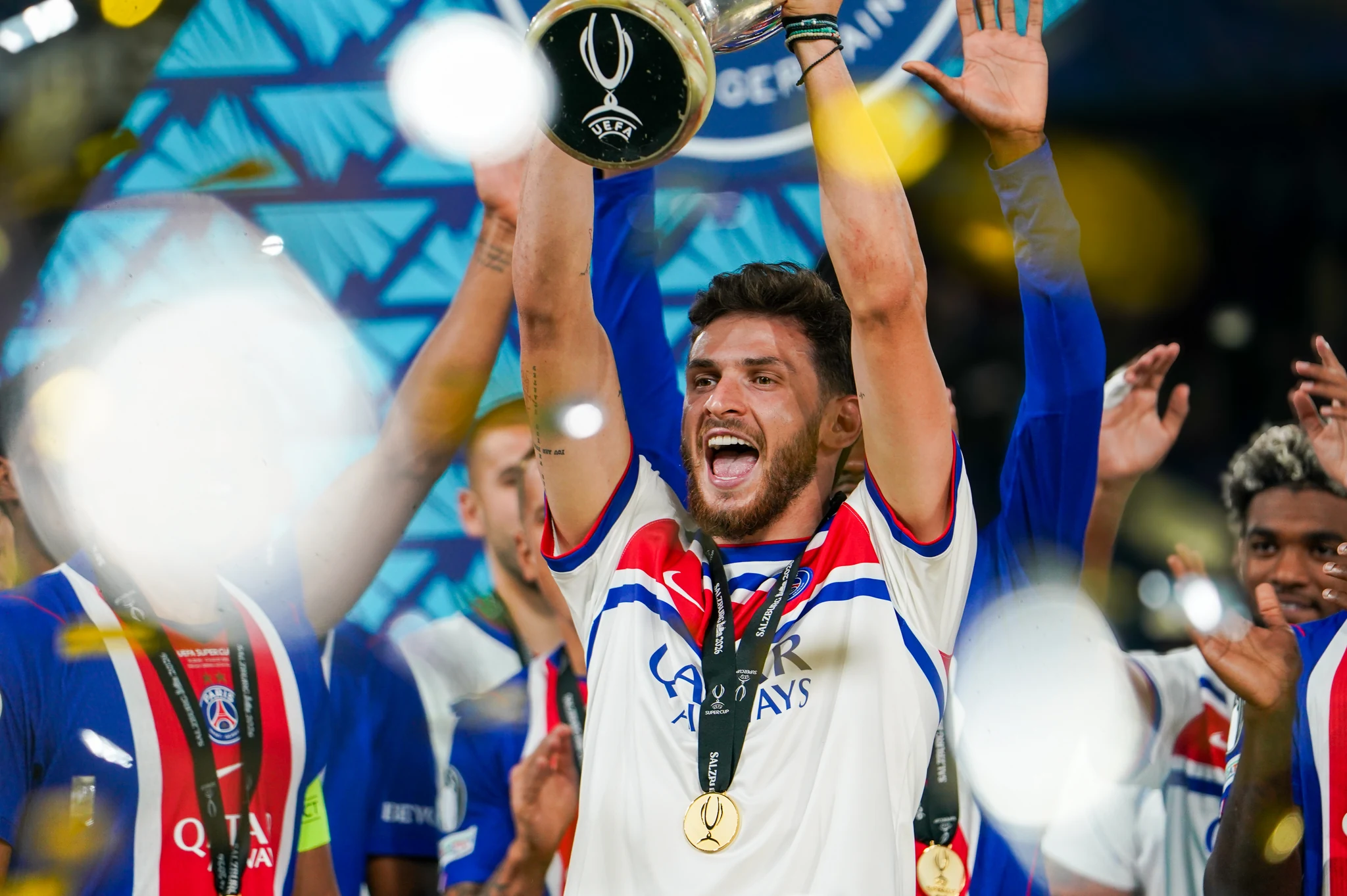 Paris Saint-Germain players celebrate with the UEFA Super Cup trophy.