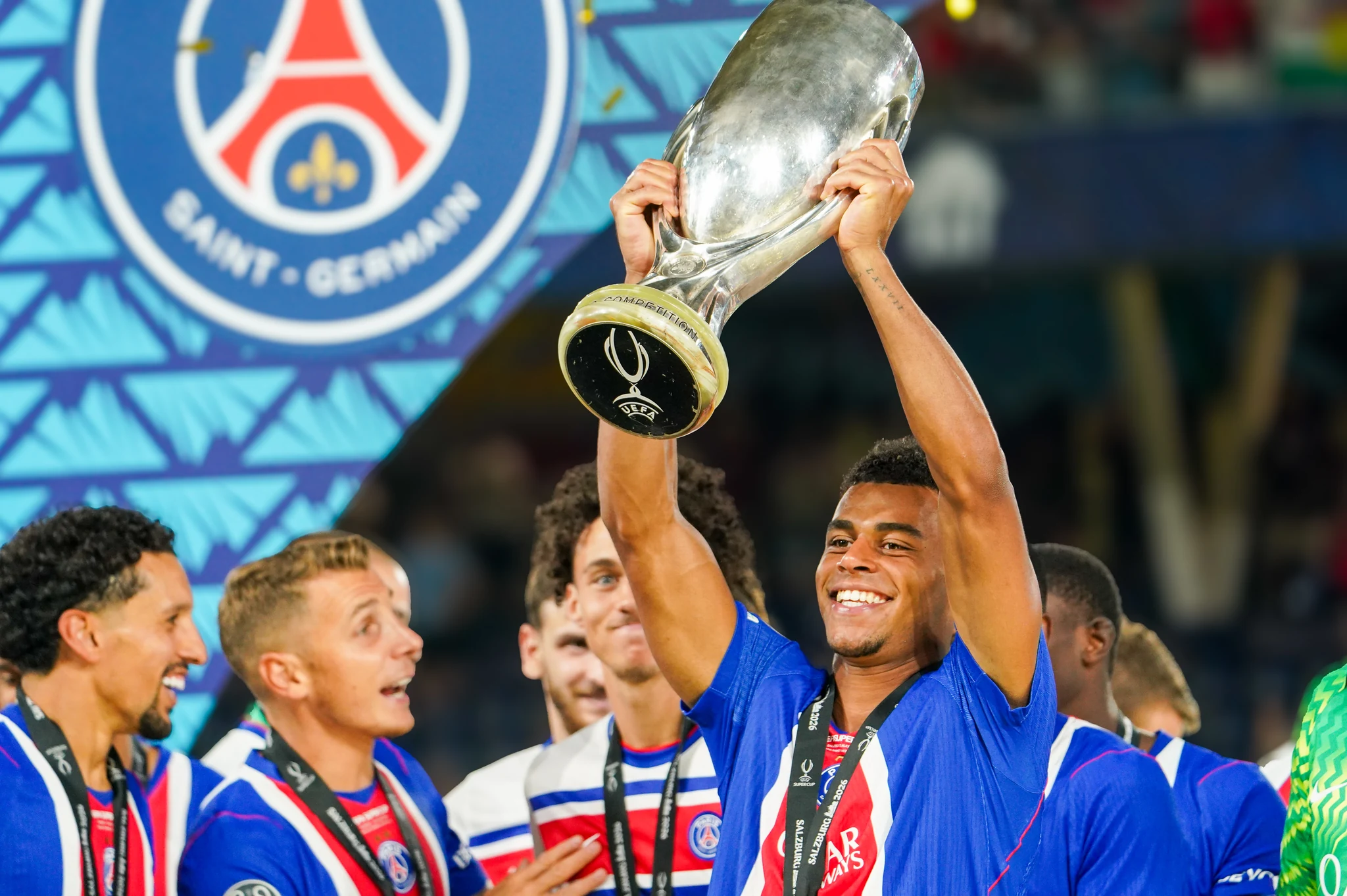 Paris Saint-Germain players celebrate with the UEFA Super Cup trophy.