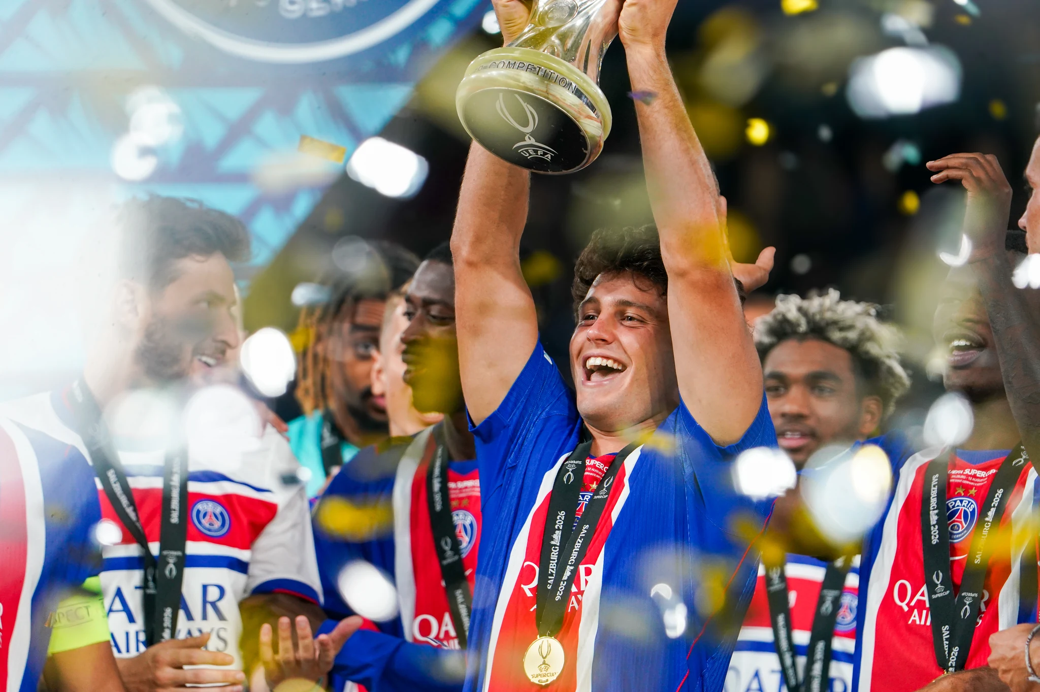 Paris Saint-Germain players celebrate with the UEFA Super Cup trophy.