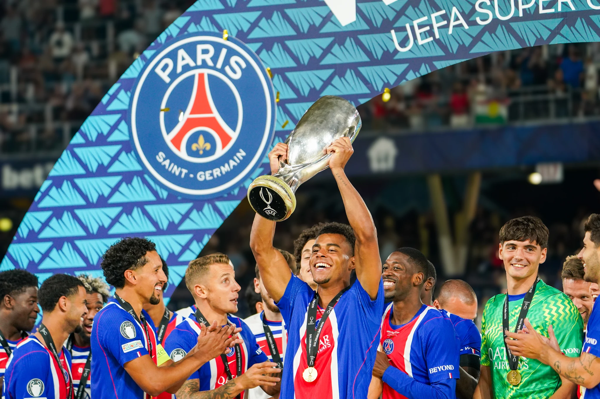 Paris Saint-Germain players celebrate with the UEFA Super Cup trophy.