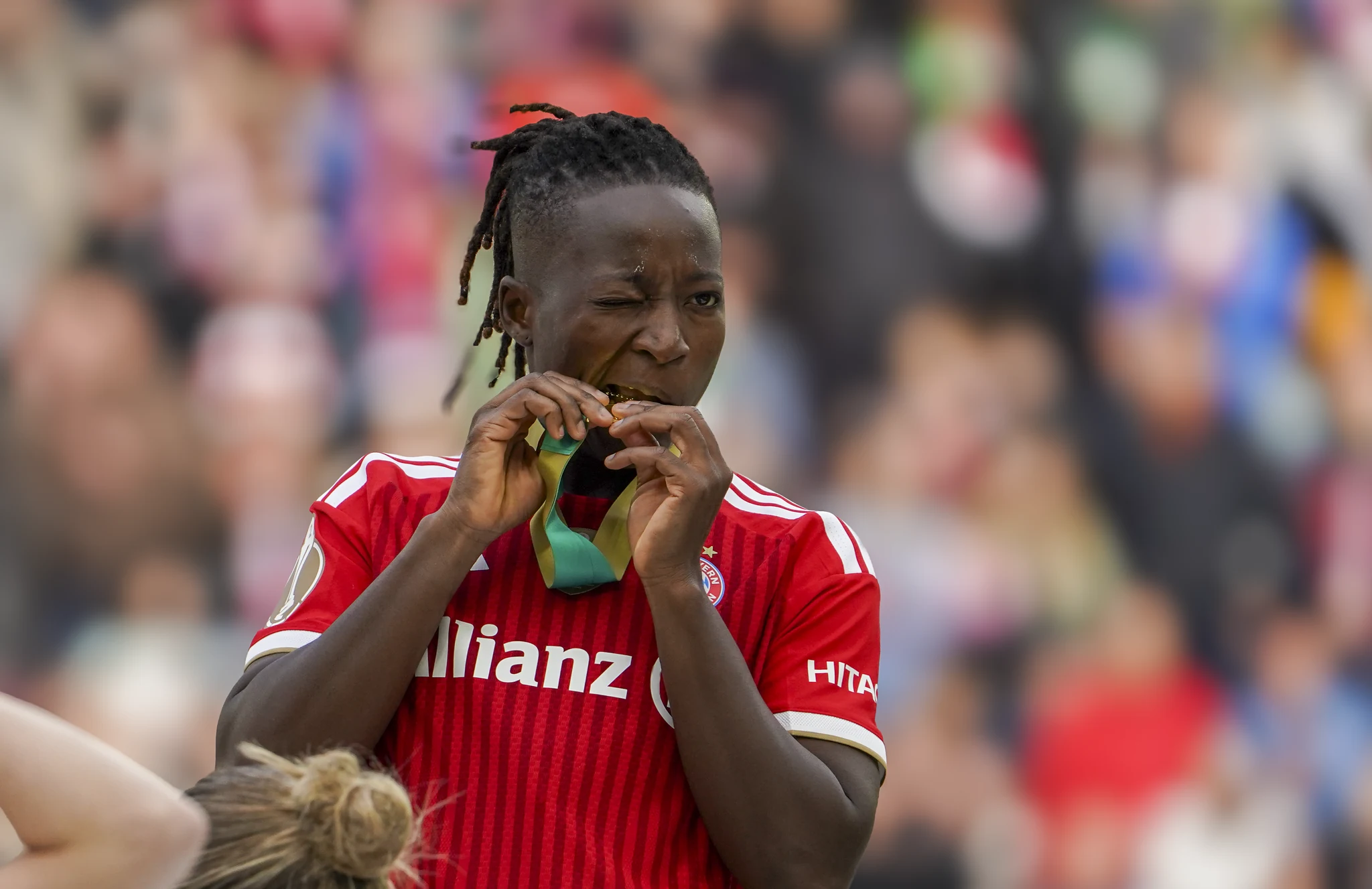 A Bayern Munich player kisses her winner’s medal.