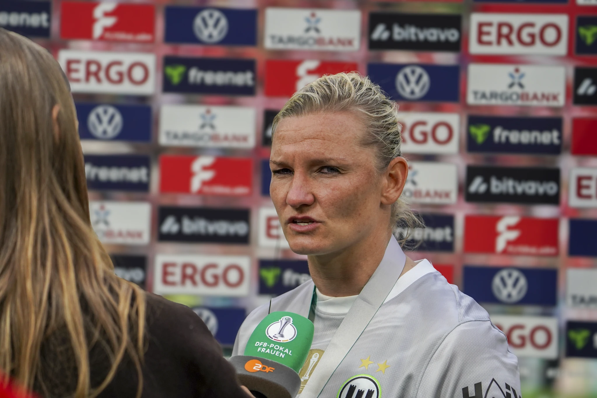 A Wolfsburg player speaks to the media after the match.