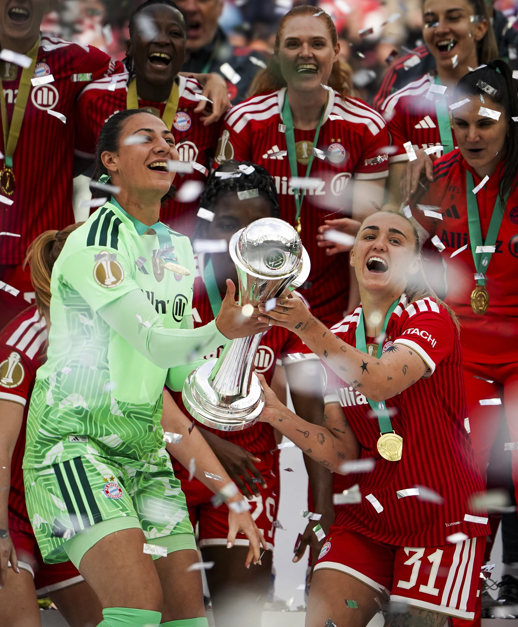 Bayern Munich celebrate with the cup and confetti in Cologne.